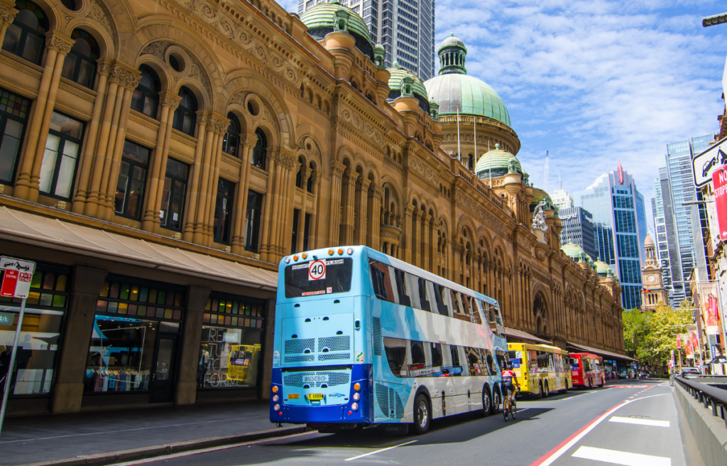 Local buses passing by a historic building in Sydney Australia: Travel guide to Sydney By Ali Reza.