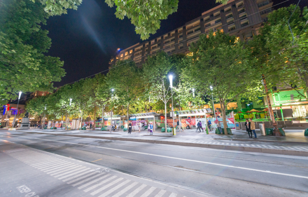 MELBOURNE - OCTOBER 2015: Tourists visit city streets at night. Melbourne attracts 15 million people annually.
