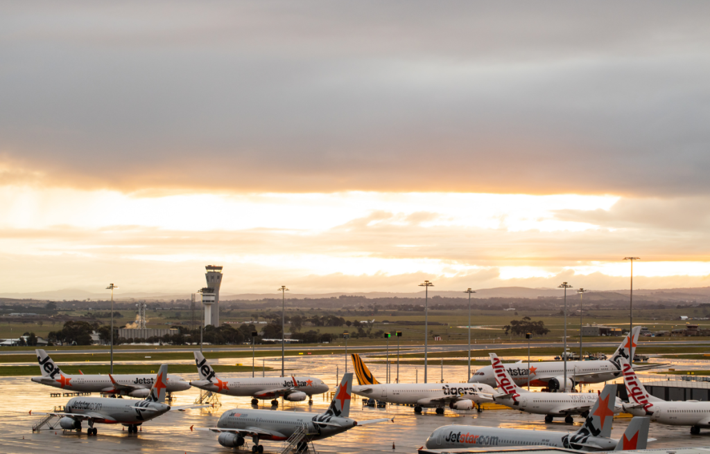 Melbourne, Victoria, Australia - July 3rd 2020: Melbourne Tullamarine airport with aeroplanes grounded on the tarmac. Melbourne Tullamarine airport with Virgin, Jetstar and Tiger aeroplanes grounded on the tarmac during the Corona COVID-10 pandemic, the air traffic control tower is in the back ground